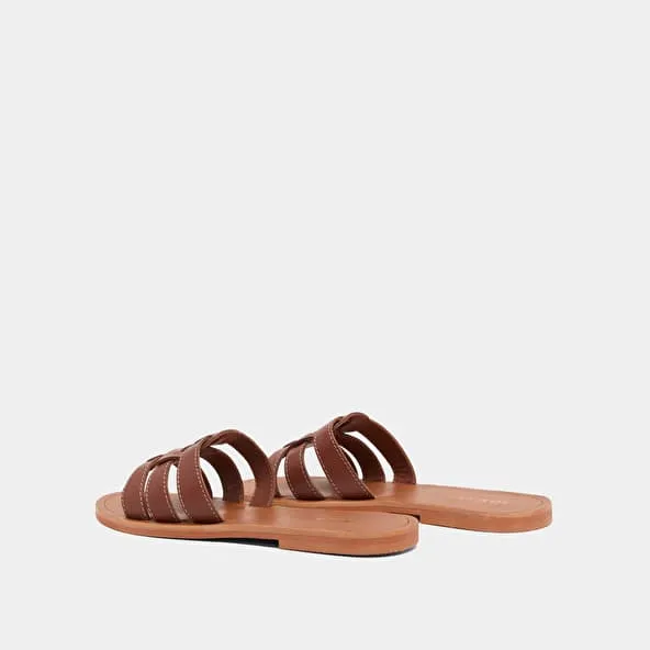 Cross-strap mules in cognac leather