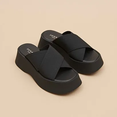 Cross-strap wedge mules in black elastic