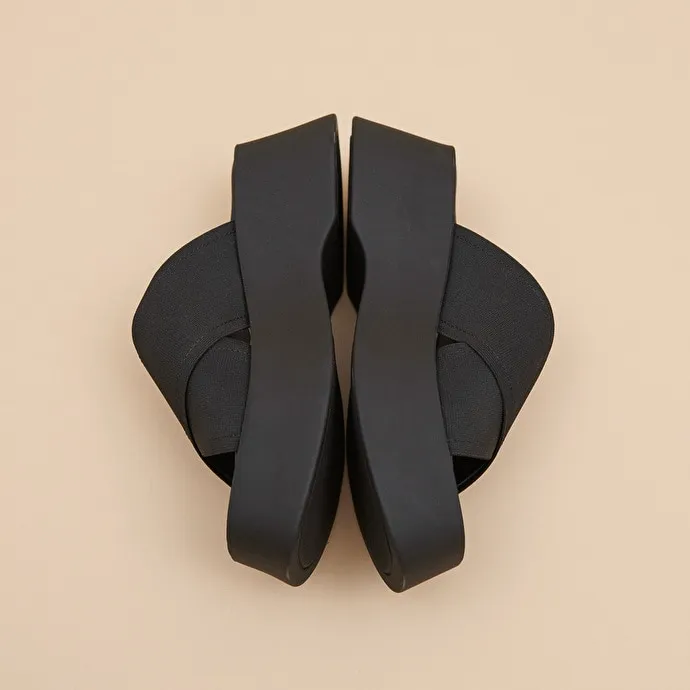 Cross-strap wedge mules in black elastic