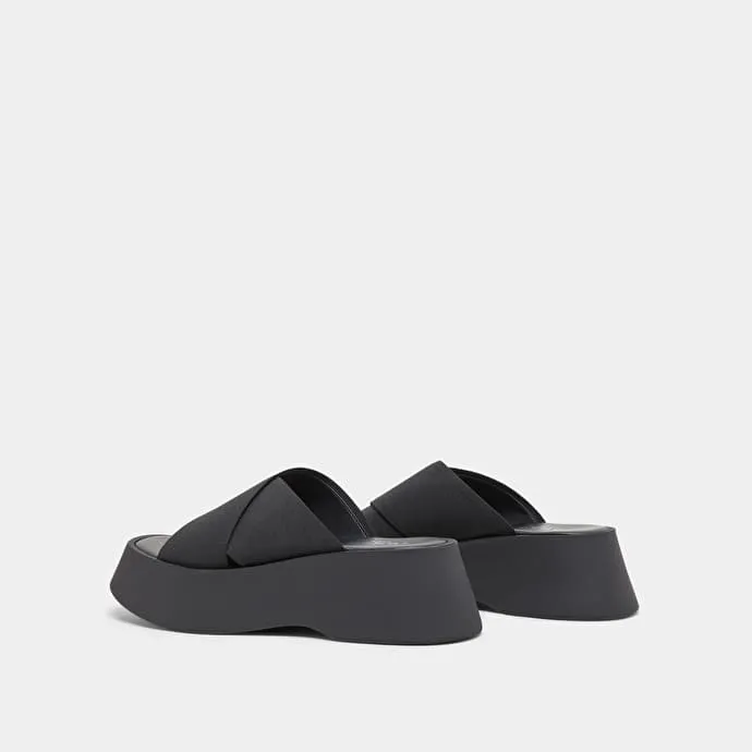 Cross-strap wedge mules in black elastic