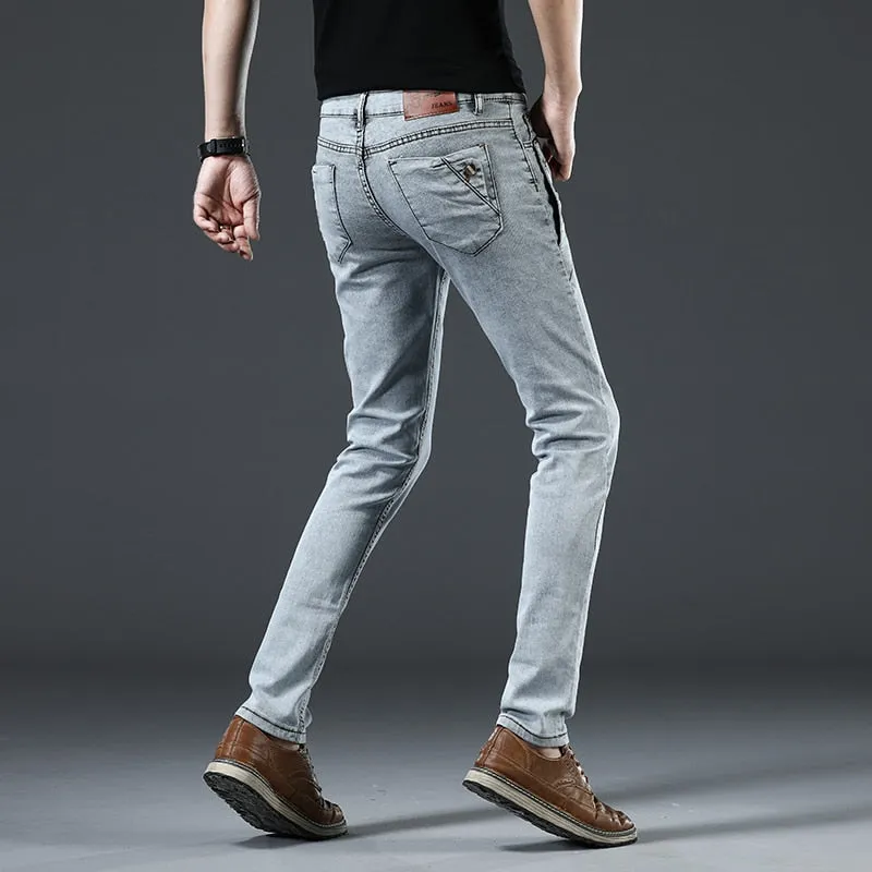 Fashion Men's Slim Fit Cotton Jeans with Button Pocket in Solid Pattern and Mid Waist